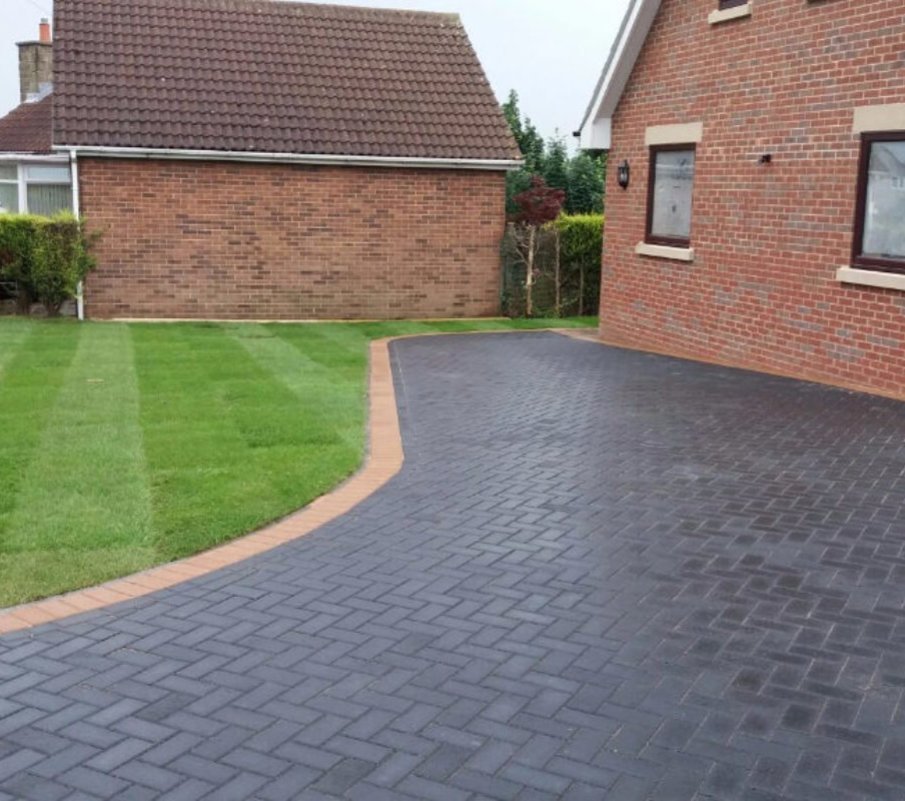 Tarmac driveway in red with aco drains and a hidden soakaway driveway